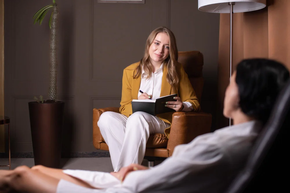 young woman makes entry her diary looks client